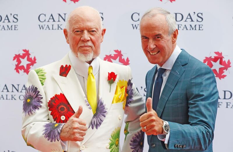 FILE PHOTO: Storied Canadian hockey sportscasters Don Cherry (L) and Ron MacLean, hosts of "Coach's Corner on Hockey Night in Canada", unveil their 2015 Canada's Walk of Fame star on King St in Toronto, Ontario Canada July 25, 2016.     REUTERS/Mark Blinch/File Photo