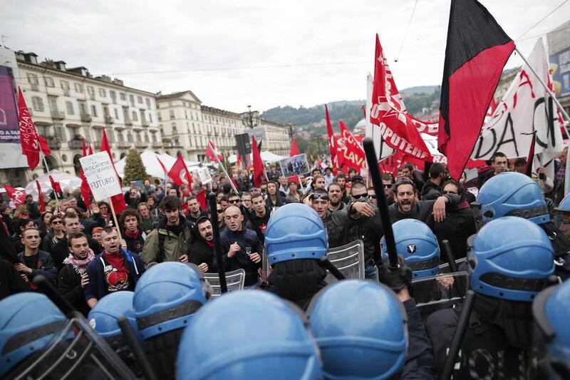 Anti-riot policemen clash with demonstrators in Turin during one of several rallies against unemployment and austerity in Italy for May Day. Marco Bertorello / AFP Photo