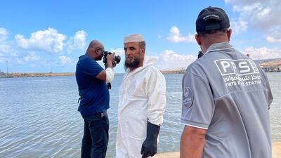 Hafez Obeid, head of the forensics team in Derna, awaits for the UAE marine rescue team to recover a car that fell into the port. Ismaeel Naar / The National