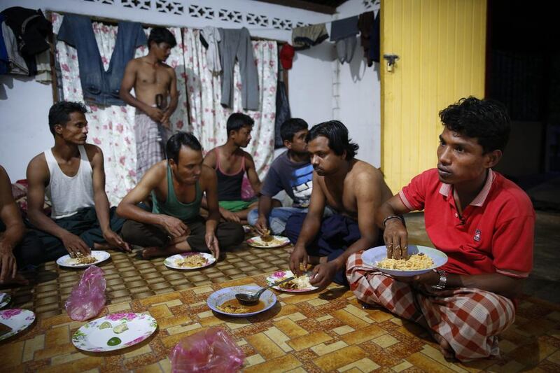 Mohamad Husein, right, from Myanmar, eats dinner at his hostel with his compatriots on the outskirts of Alor Setar, Kedah, northern Malaysia. For many fleeing Rohingya, Malaysia, is the preferred destination. Around 33,000 are registered there and an equal number are undocumented, according to the Rohingya Society of Malaysia. Those numbers have swelled with the violence in Myanmar. AP Photo/Vincent Thian