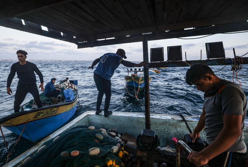 Palestinian fishermen on a convoy of boats off the coast of Gaza city, which is under Israeli blockade.