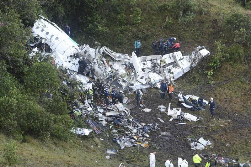 Rescue workers carry a body away from the wreckage of the chartered aeroplane was carrying the Brazilian football team Chapecoense. Luis Benavides / AP Photo