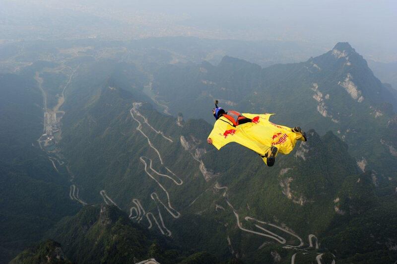 A wingsuit flying athlete performs his jump during the Red Bull wingsuit flying China Grand Prix on Sunday at Tianmen Mountain. AFP Photo