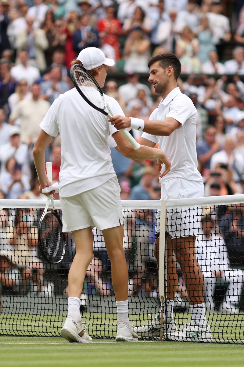 Novak Djokovic with Jannik Sinner after winning their quarter-final on Centre Court. Getty 