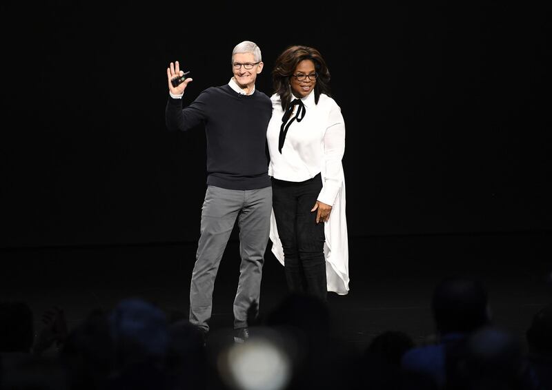 Tim Cook, chief executive officer of Apple Inc., waves while onstage with Oprah Winfrey, chief executive officer of Oprah Winfrey Network LLC, during an event at the Steve Jobs Theatre in Cupertino, California, US, on Monday, March 25, 2019. Bloomberg