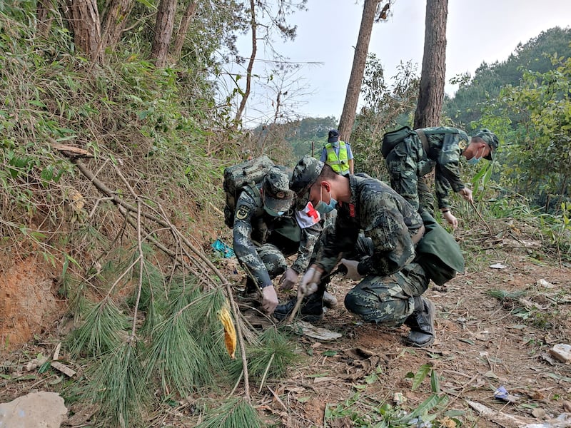 Paramilitary police officers work at the site where the aircraft crashed on March 21. Reuters