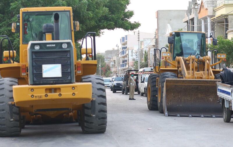 Heavy machinery gather at the scene of a Pakistan International Airlines crash the day after it occurred in a residential area, in Karachi. EPA