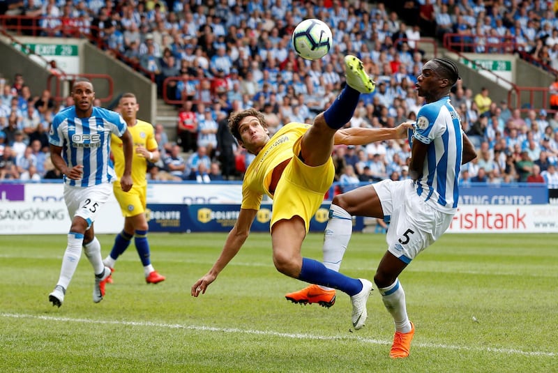 Chelsea's Marcos Alonso in action with Huddersfield Town's Terence Kongolo. Reuters