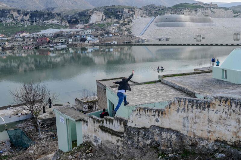 People visit abandoned houses of the ancient city of Hasankeyf in Turkey, which will be soon under water as part of a controversial dam project. AFP