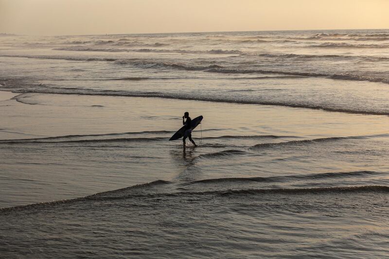 A Palestinian surfer on a beach west of Gaza City, on Saturday, February 22. EPA