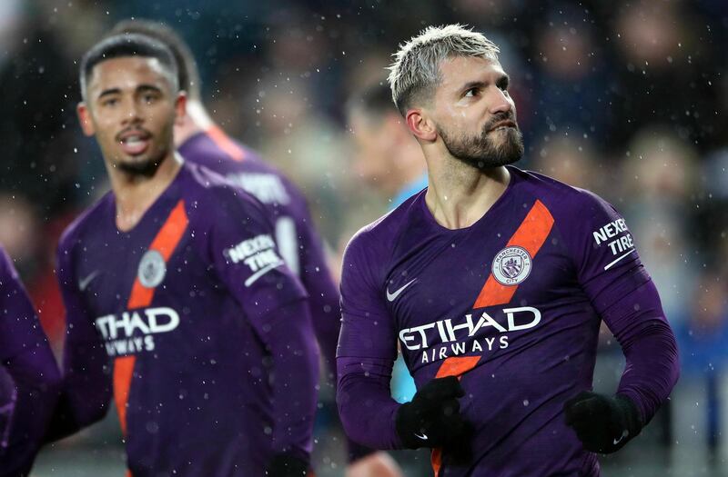 Manchester City's Sergio Aguero, right, celebrates scoring his side's third goal of the game during their English FA Cup quarter final soccer match against Swansea City at the Liberty Stadium, Swansea, Wales, Saturday, March 16, 2019. (Nick Potts/PA via AP)