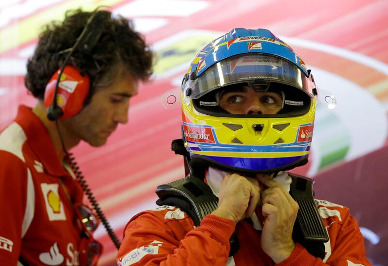 Ferrari driver Fernando Alonso of Spain removes his helmet in the pits at the end of the second free practice at the Yas Marina racetrack in Abu Dhabi, United Arab Emirates, Friday, Nov. 2, 2012. The Emirates Formula One Grand Prix will take place on Sunday. (AP Photo/Luca Bruno) *** Local Caption ***  Mideast Emirates F1 GP Auto Racing.JPEG-04e49.jpg