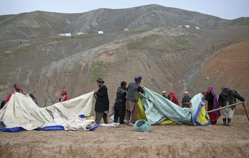 Survivors set up their temporary tents near the site of Friday's landslide that buried Abi-Barik village in Badakhshan province, northeastern Afghanistan. Massoud Hossaini / AP Photo