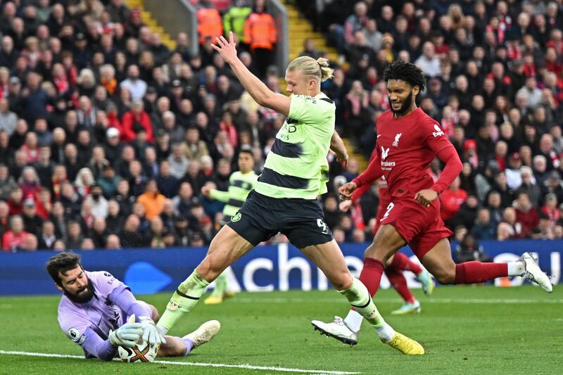 City striker Erling Haaland challenges Liverpool goalkeeper Alisson Becker in the build-up to a goal that was later ruled out after a VAR review. AFP