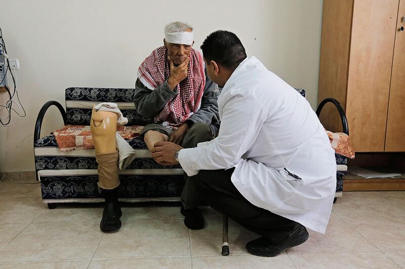 Ibrahim Zeid, 65, a Palestinian cigarette vendor and a diabetic, sits next to his artificial limb as he receives treatment at a prosthetics centre in Qalqilya. Ammar Awad / Reuters