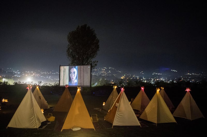 People watch movies from tents placed for social distancing at the campsites in Bandung, West Java Province, Indonesia. Reuters