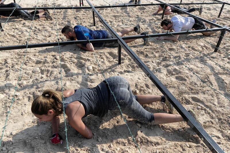 ABU DHABI, UNITED ARAB EMIRATES. 11 OCTOBER 2019. The Tough Mudder sports event held on Hudayriat Island in Abu Dhabi. The main Tough Mudder event challenged dedicated and amateur athletes with a 5km course designed to get participants moving over obstacles and along a dedicated route engineered to build team spirit. (Photo: Antonie Robertson/The National) Journalist: None. Section: National.
