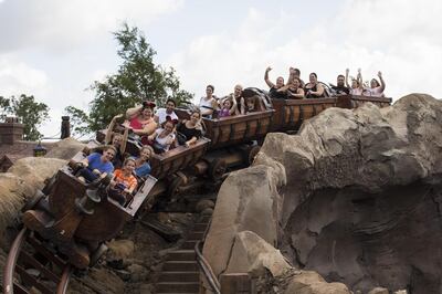 Visitors ride a roller coaster at the Walt Disney Co. Magic Kingdom park in Orlando, Florida, U.S., on Tuesday, Sept. 12, 2017. The Walt Disney Co. Magic Kingdom park reopened to a smaller-than-usual crowd after closing for two days and suffering minor storm damage from Hurricane Irma. Photographer: David Ryder/Bloomberg 