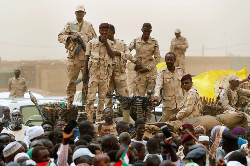 Sudanese Rapid Support Forces soldiers stand on a vehicle during a rally in southern Khartoum. AP