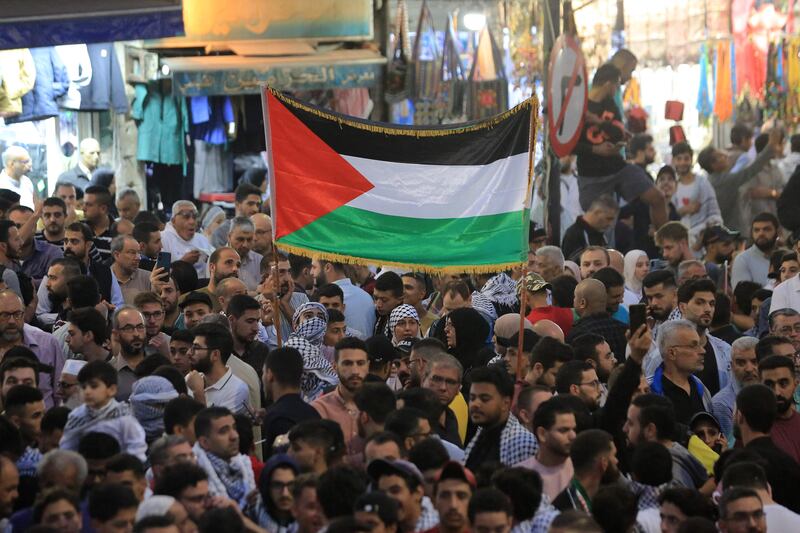 Jordanians wave the Palestinian flag as they gather to express their support for Gaza in Amman. AFP