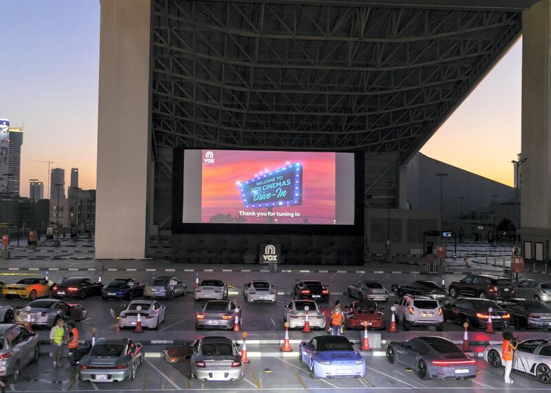 DUBAI, UNITED ARAB EMIRATES. 13 MAY 2020. The drive-in cinema is making a comeback at Mall Of The Emirates, as the property and VOX Cinemas take the movie-going experience outdoors.With social distancing measures keeping traditional theatres closed for the foreseeable future, a large screen has been assembled in the shopping centre's upper parking lot (level 3 near Ski Dubai) in front of which patrons will be able to take position, switch off their engines and settle in for some silver screen action all while observing sensible practices to combat the COVID-19 pandemic.  (Photo: Reem Mohammed/The National)Reporter:Section: