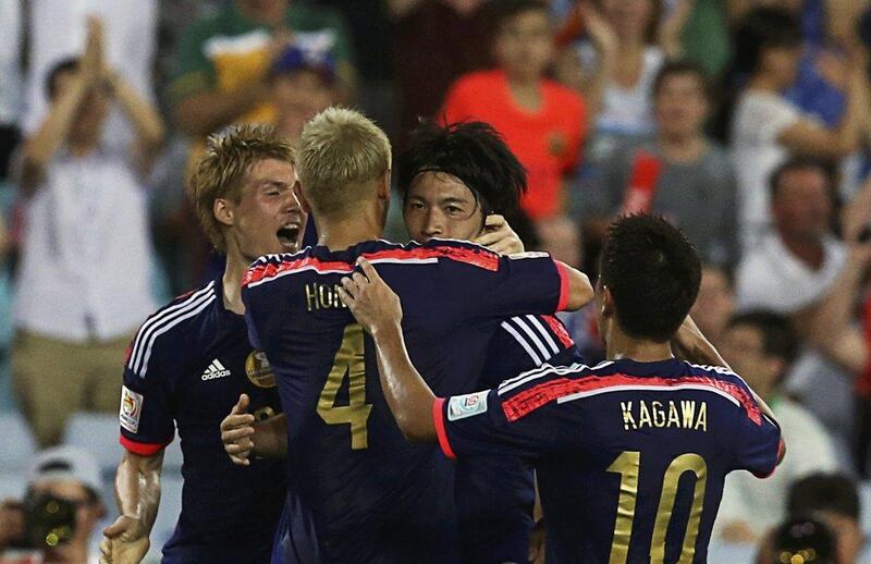 Japan's Gaku Shibasaki, second right, celebrates his 81st minute equaliser against the UAE on Friday in the Asian Cup quarter-finals. Steve Christo / Reuters