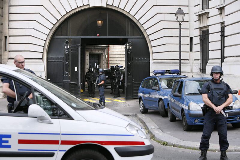 (FILES) This file photo taken on September 10, 2012 shows policemen standing guard as a convoy arrives at Paris' courthouse prior to a hearing of Abdelkader Merah, the brother of Islamist gunman Mohamed Merah as part of the investigation into the killings in Toulouse. 
The trial of Abdelkader Merah begins on October 2, 2017 who stands accused of complicity in the series of shootings commited by his jihadist brother Mohamed Merah in Toulouse and Montaubau in 2012, in which three children and a teacher were killed at a Jewish school in Toulouse, as well as three French paratroopers in two other attacks, before being killed himself on March 22 following a 32-hour police siege at his flat.
 / AFP PHOTO / KENZO TRIBOUILLARD
