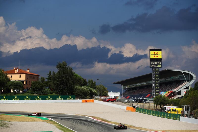 Alfa Romeo's Kimi Raikkonen and Max Verstappen of Red Bull during the race. Getty