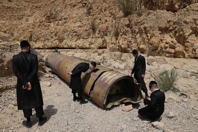 Ultra-Orthodox Jews inspect an Iranian ballistic missile fired by Iran's Islamic Revolutionary Guards Corps on April 14. EPA