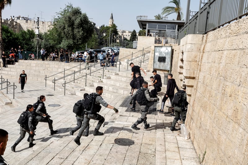 Israeli police remove Palestinians from the stairs near the Damascus Gate leading to Jerusalem's Old City. Reuters