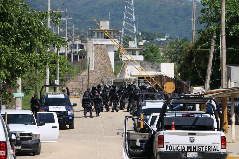 Riot police enter a prison after a riot broke out at the maximum security wing in Acapulco