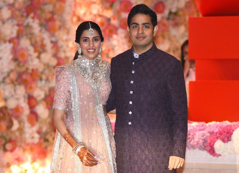 Akash Ambani (R), the eldest son of India's richest man and Reliance Industries Limited Chairman, Mukesh Ambani, and fiancee Shloka Mehta pose at their pre-engagement party in Mumbai on Thursday night. AFP