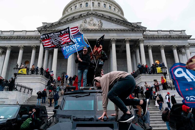 Supporters of US President Donald Trump protest outside the US Capitol on January 6, 2021, in Washington, DC. Demonstrators breeched security and entered the Capitol as Congress debated the a 2020 presidential election Electoral Vote Certification. / AFP / ALEX EDELMAN
