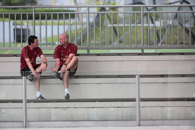 Manager Unai Emery, left, and assistant coach Steve Bould converse before a team training session. EPA