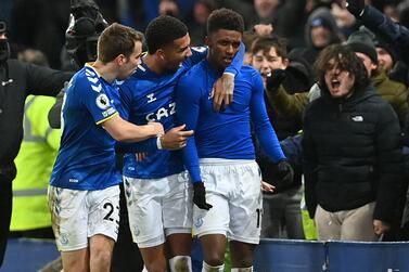 Everton's English striker Demarai Gray (C) celebrates with teammates after scoring their late second goal during the English Premier League football match between Everton and Arsenal at Goodison Park in Liverpool, north west England on December 6, 2021.  (Photo by Paul ELLIS / AFP) / RESTRICTED TO EDITORIAL USE.  No use with unauthorized audio, video, data, fixture lists, club/league logos or 'live' services.  Online in-match use limited to 120 images.  An additional 40 images may be used in extra time.  No video emulation.  Social media in-match use limited to 120 images.  An additional 40 images may be used in extra time.  No use in betting publications, games or single club/league/player publications.   /  