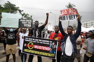 People demonstrate on the street to protest against police brutality in Lagos, Nigeria, Wednesday, Oct. 14, 2020, for a seventh day across Africa's most populous nation. (AP Photo/Sunday Alamba)