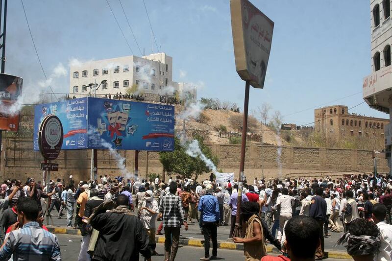 Houthi fighters and pro-Houthi police fire tear gas on anti-Houthi protesters demonstrating in Yemen's southwestern city of Taez on March 22. Reuters