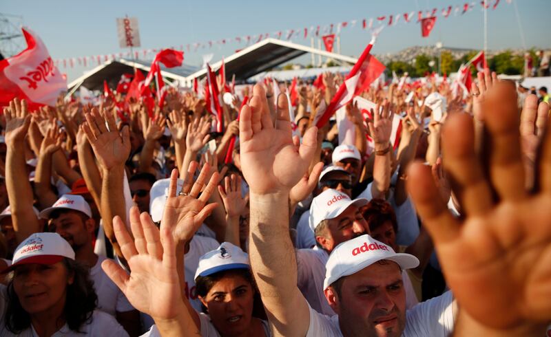 Supporters of Kemal Kilicdaroglu, the leader of Turkey's main opposition Republican People's Party, raise their hands as they gather for a rally in Maltepe, Istanbul on July 9, 2017, celebrating the end of Mr Kilicdaroglu's 425-kilometre 'March for Justice' from Ankara to Istanbul. Lefteris Pitarakis / AP Photo