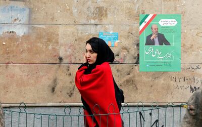 epa08223873 An Iranian woman walks past an electoral billboard in a street of Tehran, Iran, 17 February 2020. Iranians will go to the polls to vote in the parliamentary elections on 21 February 2020.  EPA/ABEDIN TAHERKENAREH