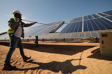 A man cleans solar panels at the Benban Solar Park in Aswan, Egypt. Solar energy is expected to take up 6% share of global electricity generation by 2029 from 2.7% at the end of 2019. EPA