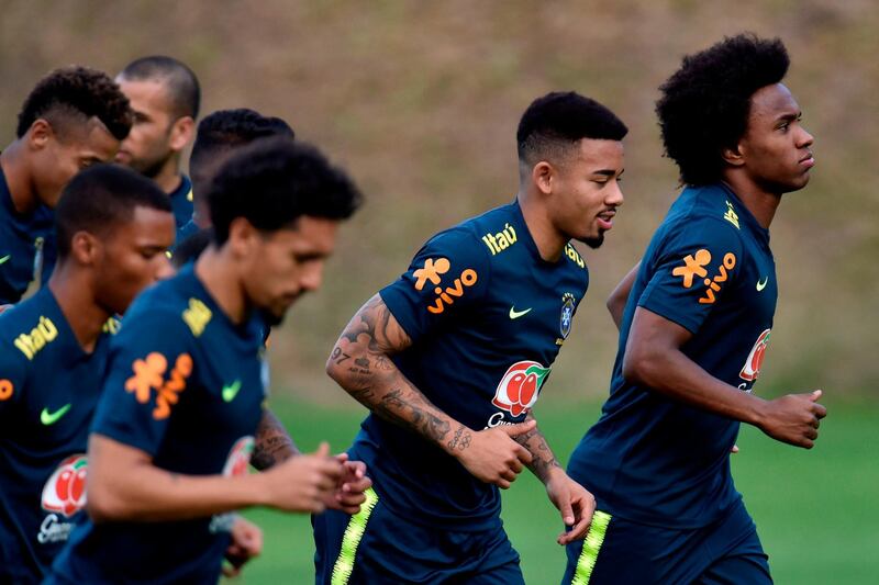 Brazil players Gabriel Jesus, second right and Willian, right, go through a warm-up. AFP