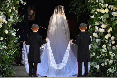 FILE - In this Saturday, May 19, 2018 file photo, Meghan Markle arrives for her wedding ceremony at St. George's Chapel in Windsor Castle in Windsor, near London, England. The outfits Prince Harry and Meghan Markle wore at their wedding are to go on public display from Oct. 26, 2018 at the ceremony's venue, Windsor Castle. (Ben Stansall/pool photo via AP, File)