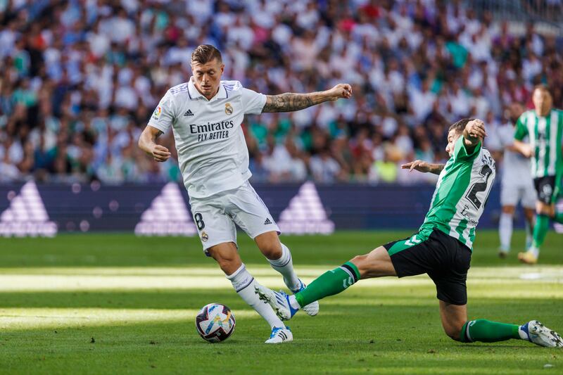 Real Madrid's Toni Kroos, left is tackled by Betis' Aitor Ruibal. AP