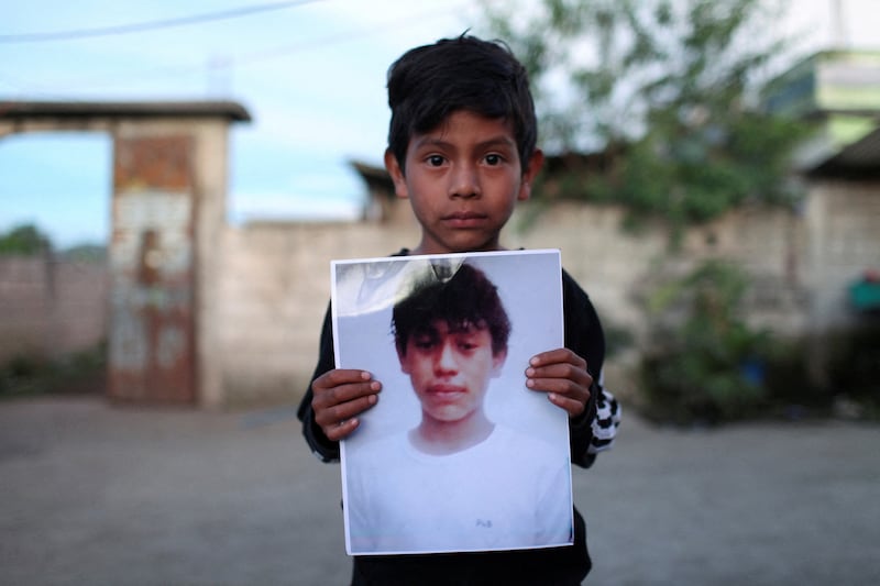 Alfonso holds a picture of 13-year-old Pascual Melvin Guachiac who died in a tractor-trailer along with other migrants in San Antonio, Texas, in a village in Nahuala, Guatemala, on June 29. Reuters