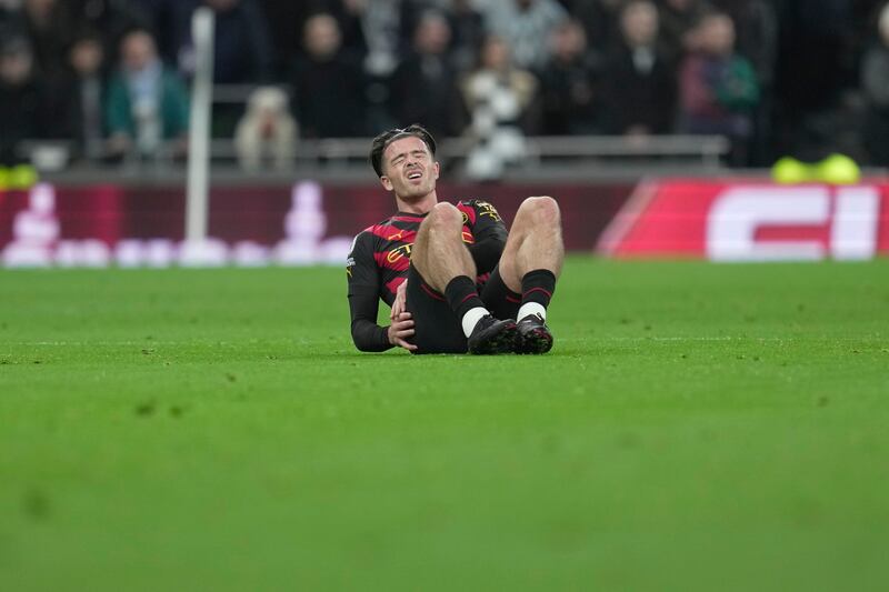 Manchester City's Jack Grealish sits injured on the pitch. AP