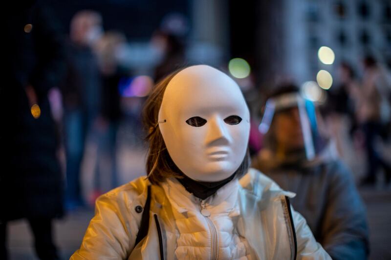 A woman wearing a face mask protests in support of coronavirus deniers and restrictions by the government in downtown Madrid, Spain. AP