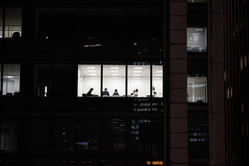 Workers are seen in an office at night in Tokyo, Japan, on Friday, March 22, 2019. Japan's Ministry of Internal Affairs and Communications will release jobs date on March 29. Photographer: Akio Kon/Bloomberg