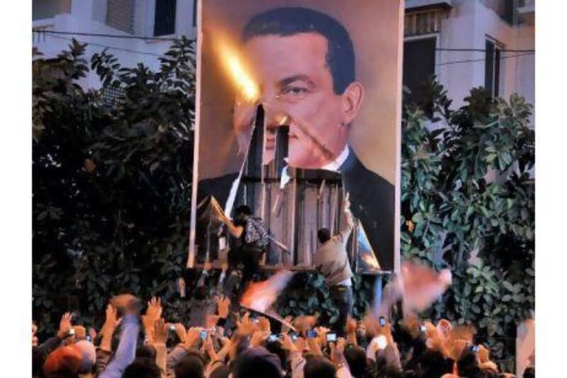 epa02696918 (FILE) A file photo dated 25 January 2011 shows Egyptian protesters tearing down a poster of President Hosni Mubarak during a protest in Alexandria, Egypt. According to local media, an Egyptian court on 21 April 2011 ruled that the name of the former President Hosni Mubarak and his wife Suzanne should be removed from all public facilities in the country. After nearly 30 years in power, Mubarak was forced to step down on 11 February following 18 days of nation-wide protests. EPA/AHMED YOUSSEF *** Local Caption *** 02696918.jpg