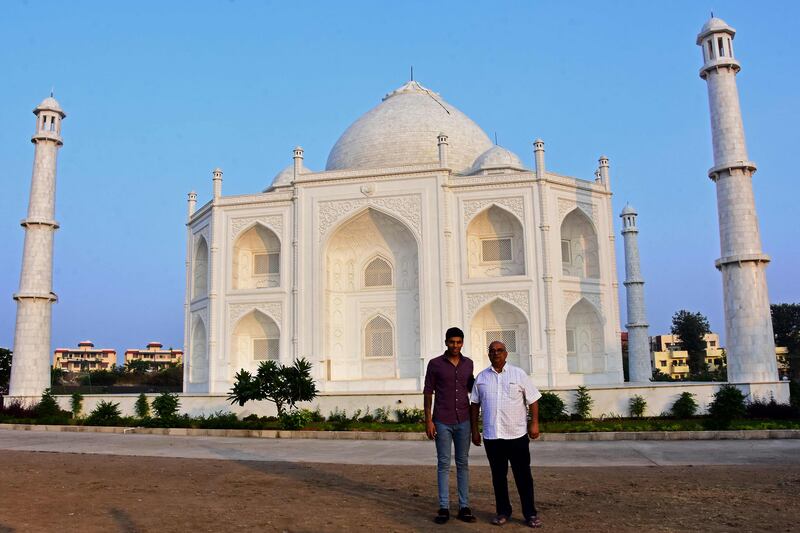 Indian businessman Anand Prakash Chouksey, right, and his son Kabir pose in front of his replica of the Taj Mahal at Burhanpur in India's Madhya Pradesh state.  AFP