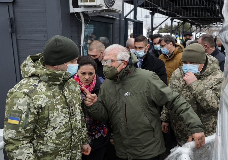 Josep Borrell, centre, visits a border crossing between Ukrainian government-held territory and an area of Russian separatist control. EPA